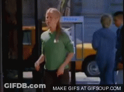 A Woman In A Green Shirt Is Dancing In Front Of A Yellow Taxi GIF