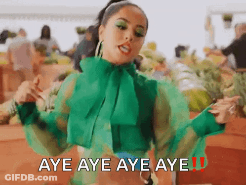 A Woman In A Green Shirt Is Dancing With The Words Aye Aye Aye Aye Written Below Her GIF