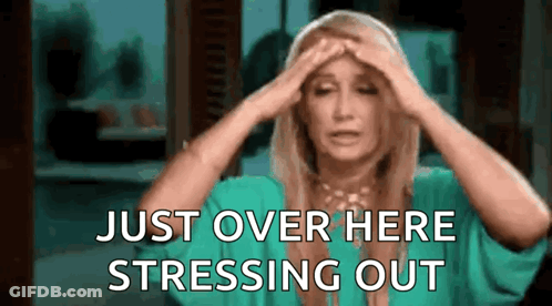 A Woman In A Green Shirt Is Holding Her Head And Saying `` Just Over Here Stressing Out '' . GIF