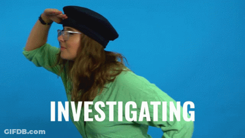 A Woman In A Green Shirt Is Investigating GIF