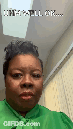 A Woman In A Green Shirt Is Making A Funny Face And Says `` Uhm Well Ok ... '' GIF