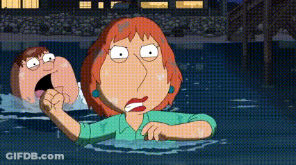 A Woman In A Green Shirt Is Standing In The Water Next To A Man In A Blue Shirt . GIF
