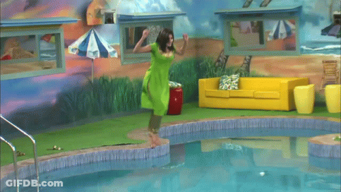 A Woman In A Green Shirt Is Swimming In A Pool GIF