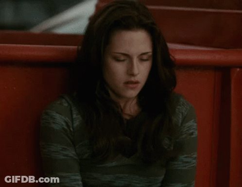 A Woman In A Green Shirt Sits In A Red Chair GIF