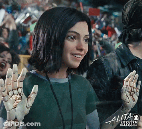 A Woman In A Green Shirt With The Word Alita Army Written On It GIF