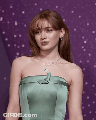 A Woman In A Green Strapless Dress With A Necklace GIF