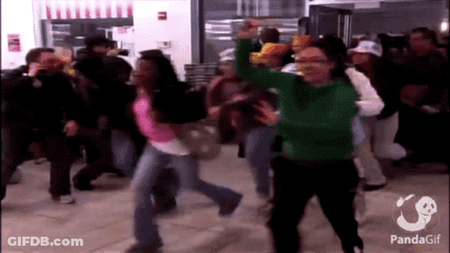 A Woman In A Green Sweater Is Dancing In A Crowd With A Panda Gif Watermark GIF