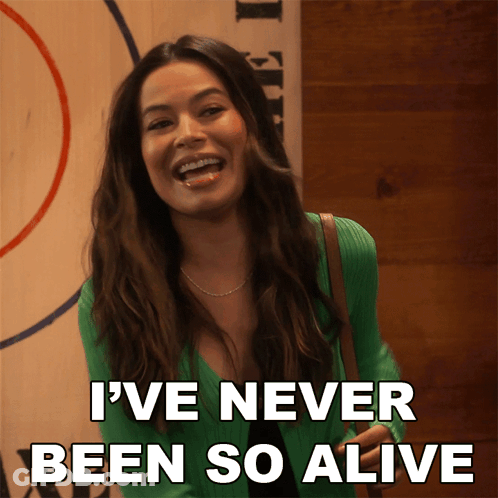 A Woman In A Green Sweater Is Laughing And Says I 'Ve Never Been So Alive GIF