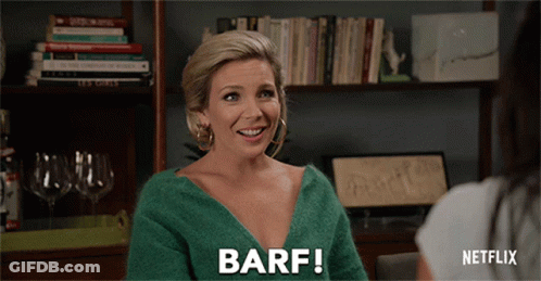 A Woman In A Green Sweater Says Barf While Talking To Another Woman GIF