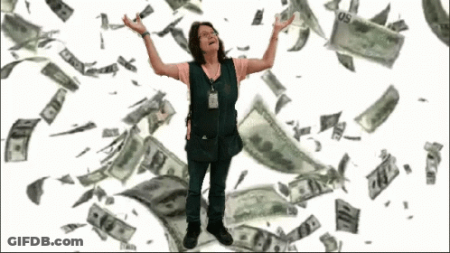 A Woman In A Green Vest Is Standing In Front Of A Pile Of Money That Is Falling From The Sky GIF