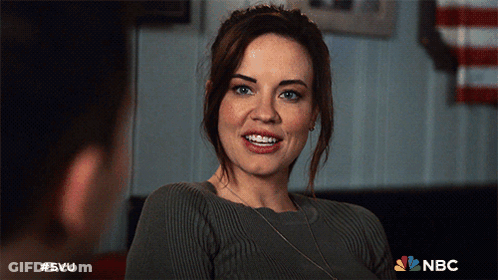 A Woman In A Grey Sweater Is Smiling In A Nbc Advertisement GIF