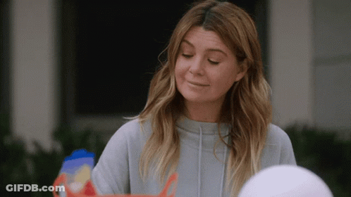 A Woman In A Grey Sweatshirt Is Looking Down GIF
