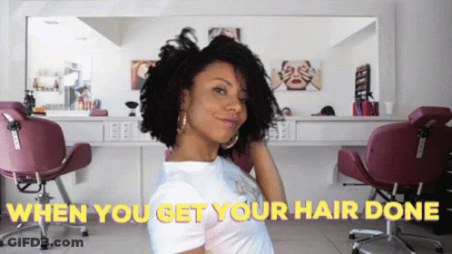 A Woman In A Hair Salon With The Words " When You Get Your Hair Done " Behind Her GIF