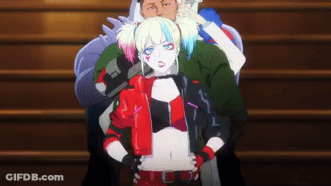 A Woman In A Harley Quinn Costume Is Standing Next To A Man On A Set Of Stairs . GIF
