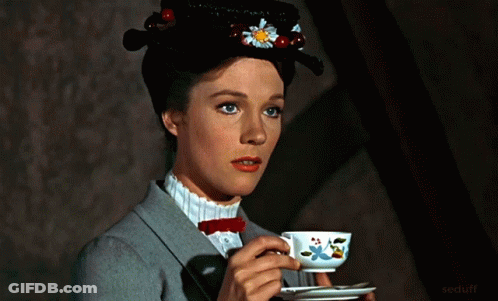 A Woman In A Hat Is Drinking From A Teacup GIF