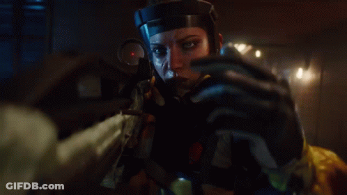A Woman In A Helmet Is Holding A Rifle In Her Hand GIF