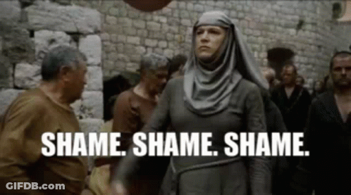 A Woman In A Hijab Is Standing In Front Of A Crowd Of People And Saying `` Shame Shame Shame . '' GIF