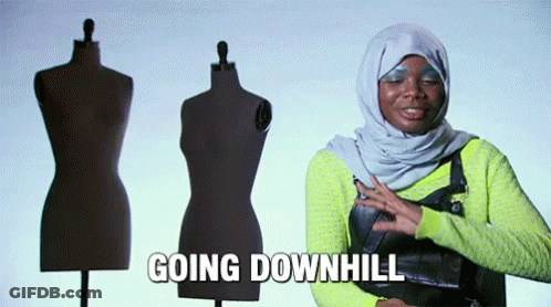 A Woman In A Hijab Is Standing In Front Of Mannequins And Says Going Downhill GIF
