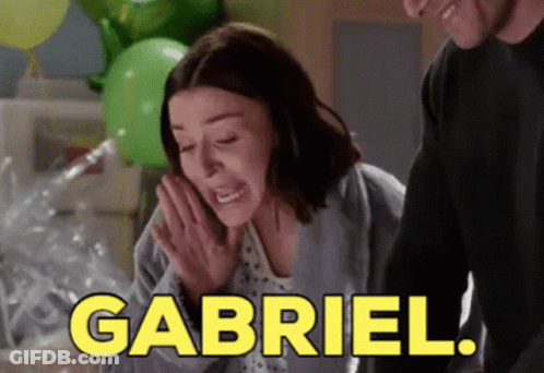 A Woman In A Hospital Gown Is Crying While A Man Stands Behind Her And Says Gabriel . GIF