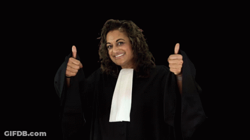 A Woman In A Judge 'S Robe Is Holding Up A Glass Of Wine GIF