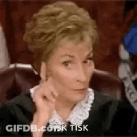 A Woman In A Judge 'S Robe Is Sitting In A Courtroom . GIF