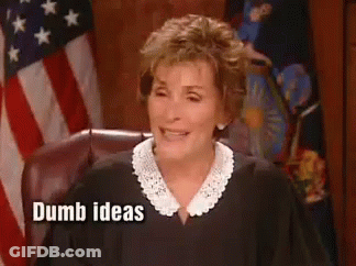 A Woman In A Judge 'S Robe Is Sitting In Front Of An American Flag . GIF