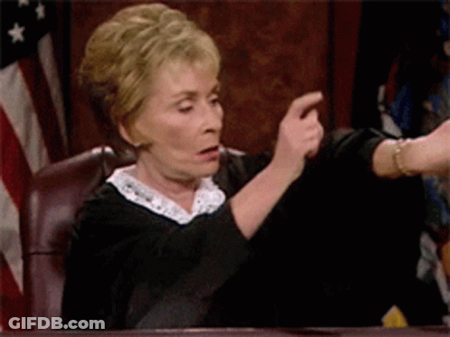 A Woman In A Judge 'S Robes Is Pointing At Someone GIF