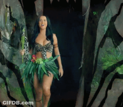 A Woman In A Jungle Outfit Is Walking Through A Zebra Print Tunnel GIF