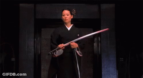 A Woman In A Kimono Is Holding A Sword . GIF