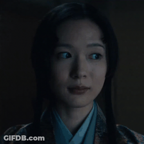 A Woman In A Kimono Is Looking At The Camera GIF