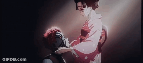A Woman In A Kimono Is Putting Her Hand On A Man 'S Forehead . GIF