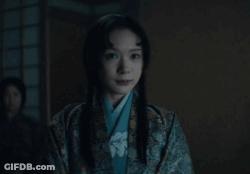 A Woman In A Kimono Looks At The Camera GIF