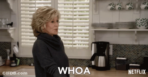 A Woman In A Kitchen Says Whoa In Front Of A Netflix Coffee Maker GIF