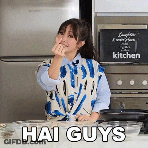 A Woman In A Kitchen With A Sign That Says Laughter & Wild Plans Come Together In The Kitchen GIF