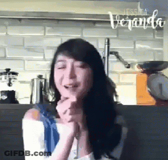 A Woman In A Kitchen With The Word Veranda On The Bottom GIF