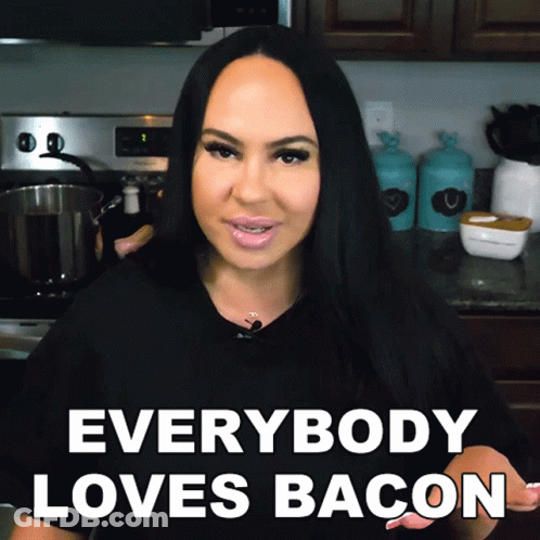 A Woman In A Kitchen With The Words " Everybody Loves Bacon " GIF