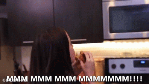 A Woman In A Kitchen With The Words " Mmmm Mmmm Mmmm Mmmm !!! " GIF