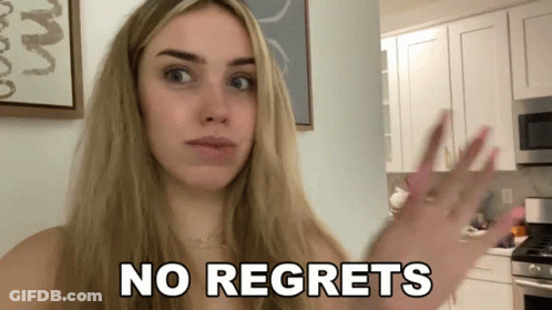A Woman In A Kitchen With The Words No Regrets On Her Face GIF