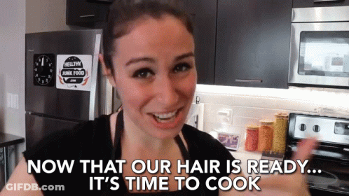 A Woman In A Kitchen With The Words Now That Our Hair Is Ready It 'S Time To Cook GIF
