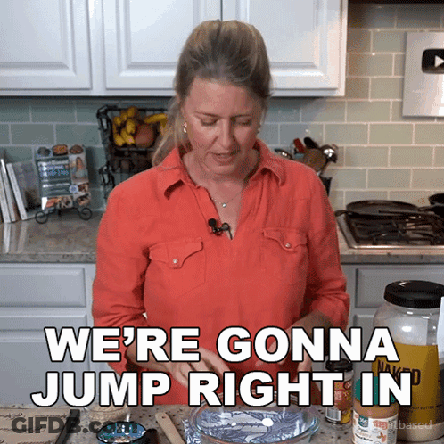 A Woman In A Kitchen With The Words We 'Re Gonna Jump Right In Above Her GIF