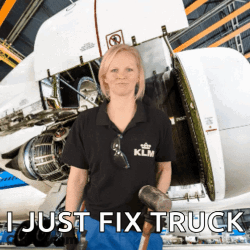 A Woman In A Klm Shirt Holds A Hammer In Front Of A Plane GIF