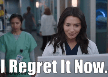 A Woman In A Lab Coat Is Looking At A Laptop With The Words " I Regret It Now " Next To Her GIF