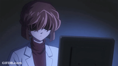 A Woman In A Lab Coat Is Looking At A Monitor GIF