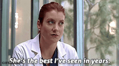 Woman In Lab Coat Sitting In Front Of Window Says She's The Best I've Seen GIF