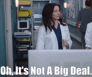 A Woman In A Lab Coat Is Standing In A Hallway With The Words Oh It 'S Not A Big Deal Written Below Her GIF