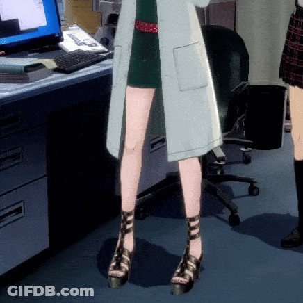 A Woman In A Lab Coat Stands In Front Of A Computer Monitor GIF