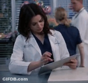 A Woman In A Lab Coat With The Letter A On Her Jacket GIF