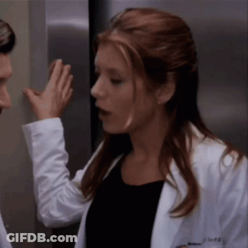 Woman In Lab Coat With AE On Chest GIF