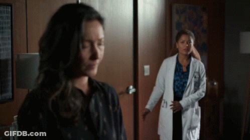 A Woman In A Lab Coat With The Number 21 On The Pocket GIF
