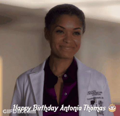 A Woman In A Lab Coat With The Words Happy Birthday Antonia Thomas GIF